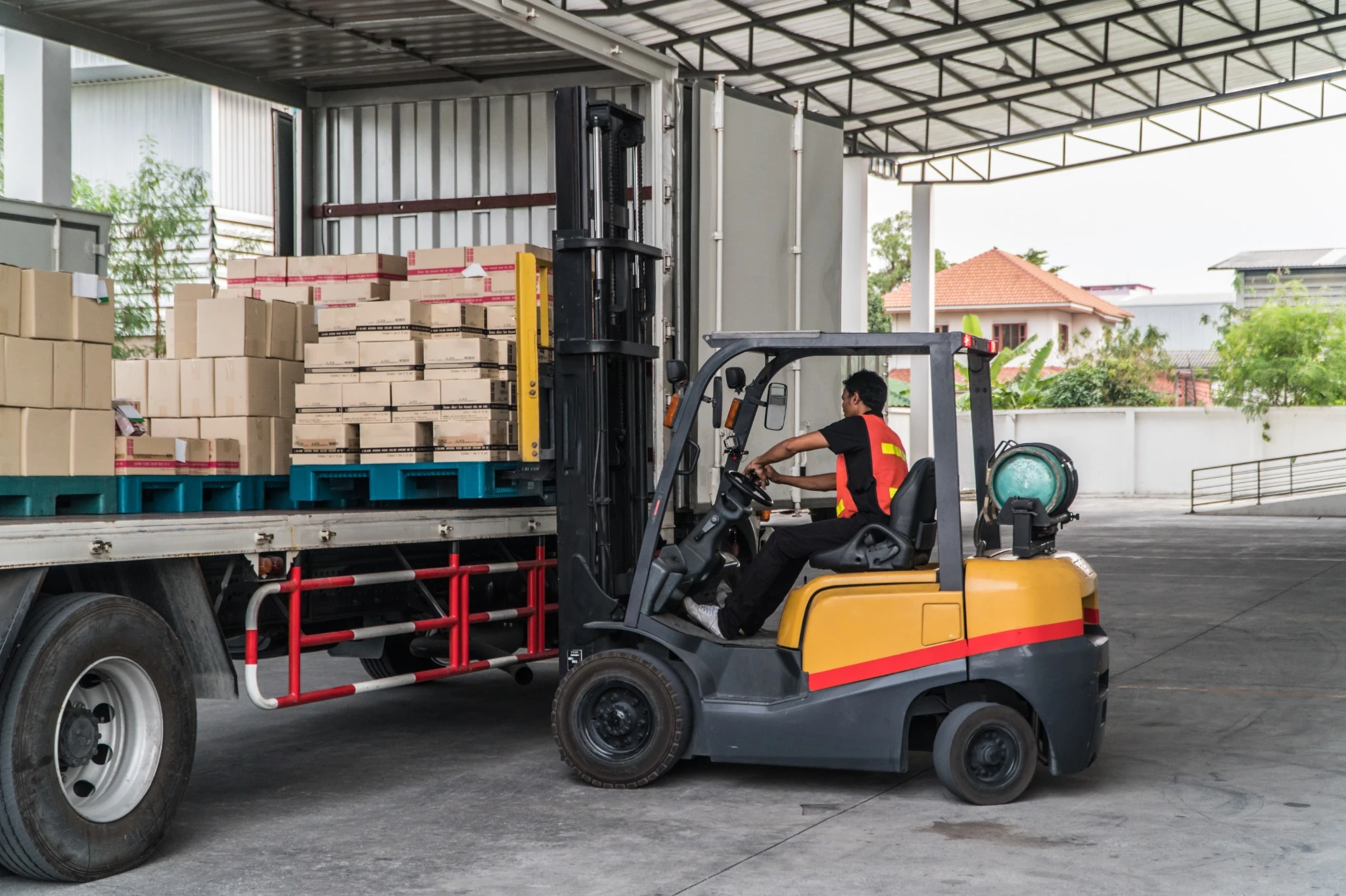 A forklift operator loads a trailer using an LPG-powered (propane) counterbalance lift truck in Ontario, Canada.